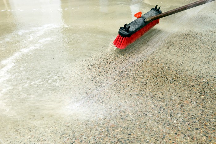 Cleaning a patio with a brush and soapy water. Getty Images Cleaning a patio with a brush and soapy water. Getty Images